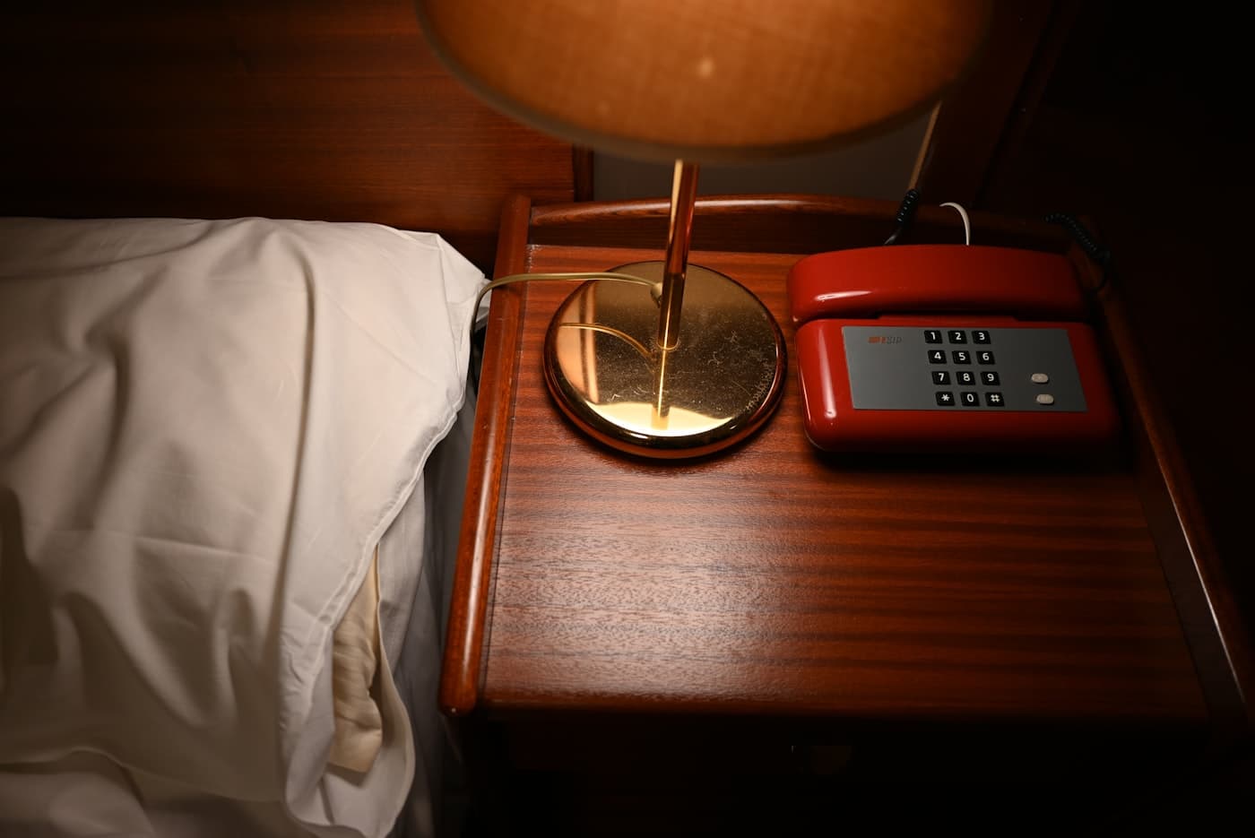 Vintage hotel room with a telephone and lamp on a table, Palermo